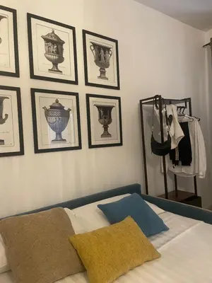 a bedroom with a bed with pictures on the wall at Apartment Luxury Navona in Rome