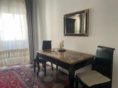 a dining room table with a mirror on the wall at Apartment Luxury Navona in Rome