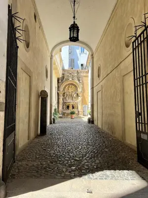 an empty alley with an archway in a building at Campo dei fiori - cozy and central apt in Rome