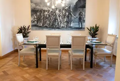 a dining room with a black table and chairs at Moon Cove, Villa Borghese Prestige Hideaway Rome in Rome