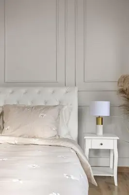 a white bedroom with a bed and a nightstand with a lamp at Maison G - new design apartment with balcony in Rome