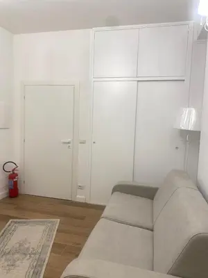 a living room with a couch and white cabinets at Colosseo luxury home in Rome