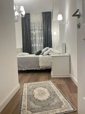 a small bedroom with a bed and a rug at Colosseo luxury home in Rome