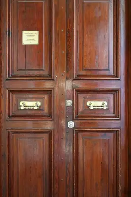 a pair of wooden doors with a sign on them at Arcudi Romance Home in Rome