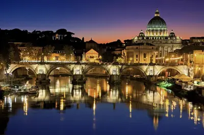 a bridge over a river with a city at night at Arcudi Romance Home in Rome