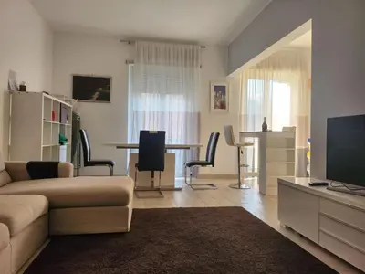 a living room with a couch and a table with chairs at P7 Casa Roma in Rome