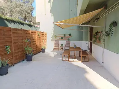 a patio with a table and chairs and a fence at CASA NONNO - Casa Vacanze in Rome