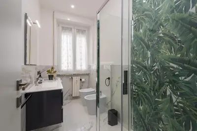 a bathroom with a shower and a toilet and a sink at Casa di Gina in Rome