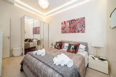 a bedroom with a bed with white towels on it at Enjoy Colosseum Apartment in Rome