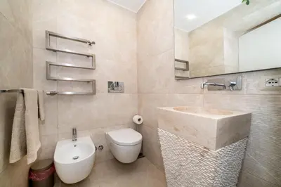 a bathroom with a sink and a toilet and a mirror at Enjoy Colosseum Apartment in Rome