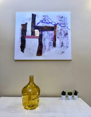 a yellow vase sitting on a table in front of a painting at Via Arese Apartment in Rome