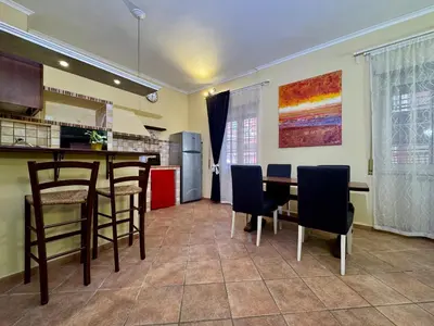 a kitchen and dining room with a table and chairs at Via Arese Apartment in Rome