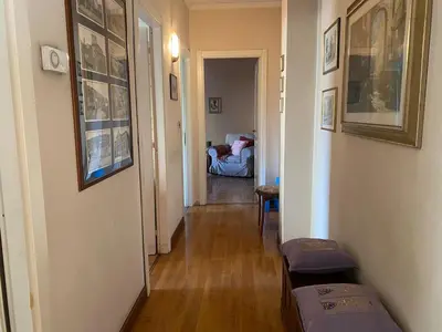 a hallway with a living room with a couch and a table at Home Luxury Emy in Rome