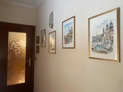 a hallway with a bunch of pictures on a wall at Home Luxury Emy in Rome