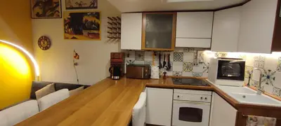 a kitchen with white cabinets and a wooden counter top at Gelsomino a San Pietro in Rome