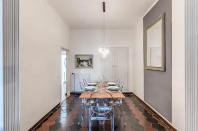 a dining room with a table and some chairs at AwesHomeItaly - Spagna Glamour Life Penthouse in Rome