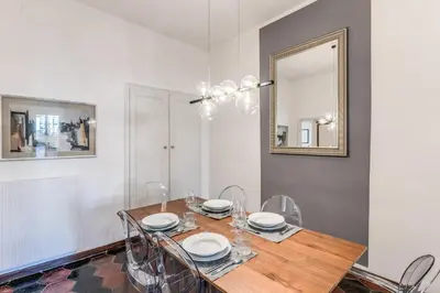 a dining room with a table with chairs and a mirror at AwesHomeItaly - Spagna Glamour Life Penthouse in Rome