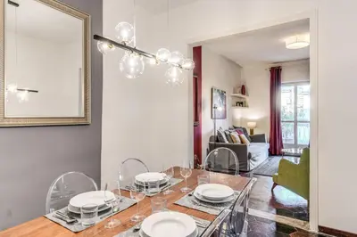 a dining room with a table and a mirror at AwesHomeItaly - Spagna Glamour Life Penthouse in Rome