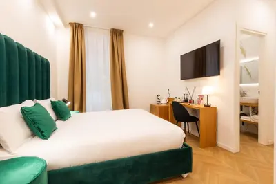a hotel room with a bed and a desk at Affresco LR Collection in Rome