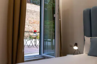 a bedroom with a large bed with a green headboard at Affresco LR Collection in Rome