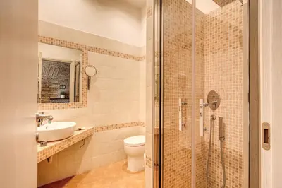 a bathroom with a shower and a toilet and a sink at Piazza di Spagna Comfort Rooms in Rome