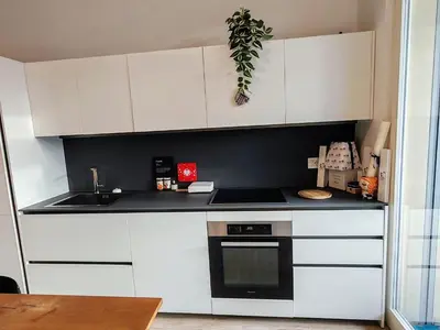 a kitchen with white cabinets and a stove top oven at Ancient Rome Studio in Rome