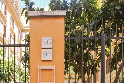 a building with a clock on the side of it at LarissaRooms in Rome
