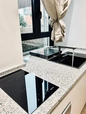 a kitchen with a black and white counter top at Luxury Nest Ponte Milvio in Rome