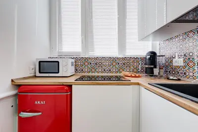 a kitchen with a red refrigerator and a microwave at New opening Ponte Milvio in Rome