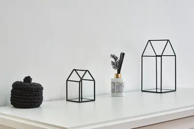 a shelf with three glass containers and a vase at Marco Polo House in Rome
