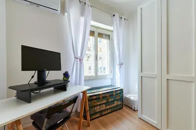 a room with a desk with a computer and a window at Marco Polo House in Rome