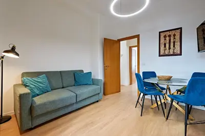 a living room with a couch and a table and chairs at Marco Polo House in Rome
