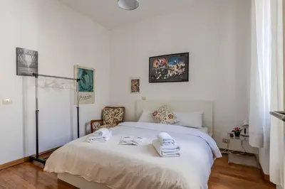 a bedroom with a white bed with towels on it at TURATI GUEST HOUSe in Rome