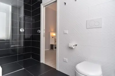 a bathroom with a toilet and a walk in shower at Lata Luxury Rooms in Rome