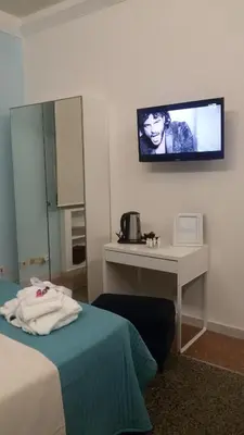 a hotel room with a tv on the wall at Ad Vatican Suites in Rome