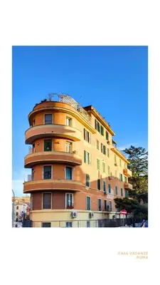 a tall yellow building with a dome on top at Appia Comfort Zone in Rome