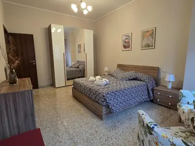 a bedroom with a bed and a mirror at Ritiro Romano in Rome