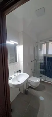 a white bathroom with a sink and a toilet at Alloggio Turistico A casa di Anna in Rome