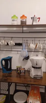 a kitchen counter with a coffee maker on a shelf at Alloggio Turistico A casa di Anna in Rome