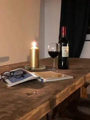 a table with a bottle of wine and a glass at PianoDue In Trastevere in Rome