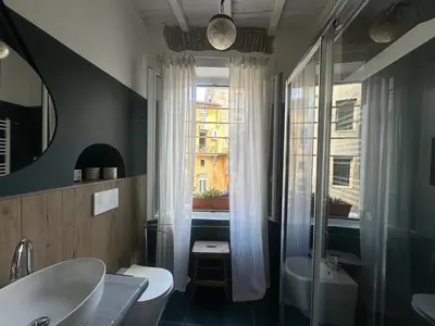a bathroom with a sink and a toilet and a window at PianoDue In Trastevere in Rome