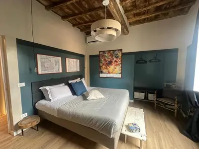 a bedroom with a large bed with blue walls at PianoDue In Trastevere in Rome