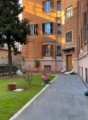 an empty sidewalk in front of a building at MNC House Roma in Rome