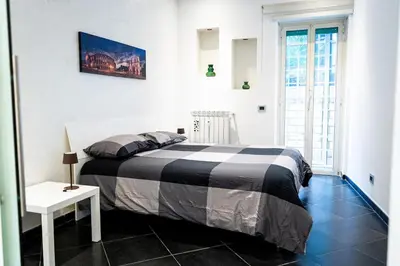 a bedroom with a bed with a black and white blanket at Sanpietrino Apartment in Rome