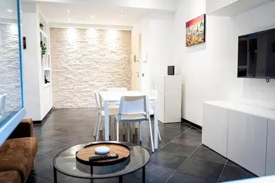a kitchen and living room with a table and chairs at Sanpietrino Apartment in Rome