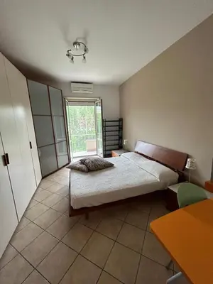 a bedroom with a large bed and a window at Alloggio turistico AVM in Rome