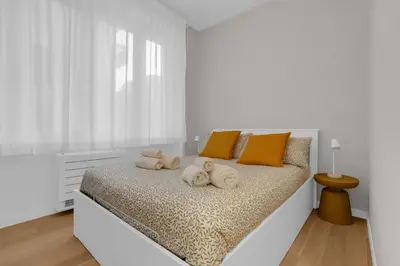 a white bedroom with a bed with towels on it at SANSO HOUSE - 2 bedrooms, 2 bathrooms, AC - for family in Rome