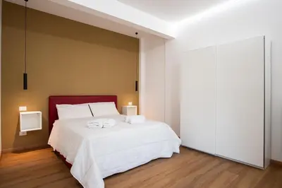 a bedroom with a large white bed with towels on it at Da Eleonora - Centro di Roma in Rome