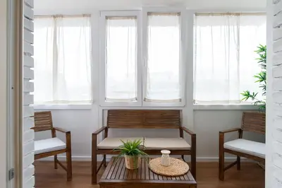 two chairs and a table in a room with windows at Da Eleonora - Centro di Roma in Rome