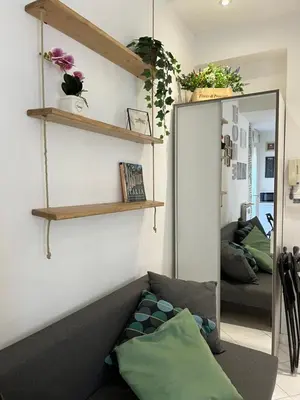 a living room with a couch and a mirror at Vatican Loft a pochi passi da piazza San Pietro in Rome
